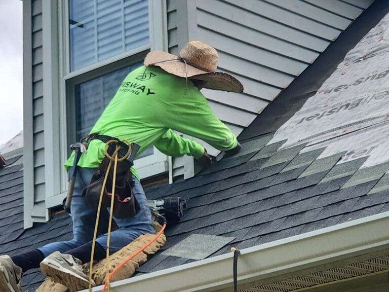 Hisway Roofing contractor working on repairing a roof.